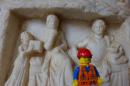 small carved people: base of a column situated outside the hospital ward in Rhodes